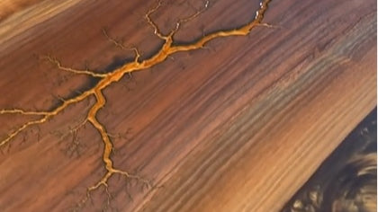 Have you tried using epoxy resin on fractal burnt wood?