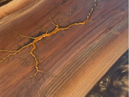 Have you tried using epoxy resin on fractal burnt wood?